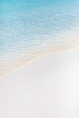 Fototapeta na wymiar Soft wave of ocean on sandy beach, copy space, background.