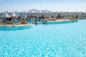 Fototapeta na wymiar Close-up of blue water pool with blurry background