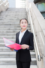 female staff holding a folder