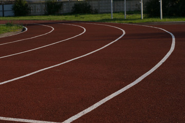 Running track in the stadium. Rubber coating. Treadmill in the fresh air. Healthy lifestyle concept. Athletes cardio workout