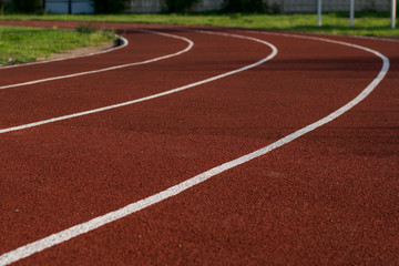 Running track in the stadium. Rubber coating. Treadmill in the fresh air. Healthy lifestyle concept. Athletes cardio workout