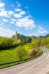 Fototapeta na wymiar Orava Castle on the high steep rock near the rock. one of the most beautiful medieval fortress in Slovakia. popular travel destination. beautiful sunny day. trees in green foliage
