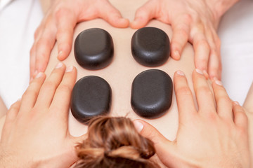 Back massage with stones.