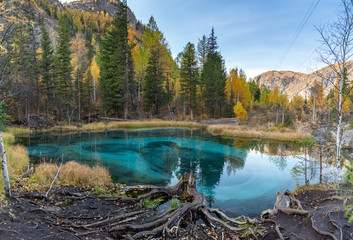 Blue geyser lake in the mountains