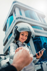 astronaut girl smiling fist bumpers using smartphone, in futuristic building, lifestyle concept