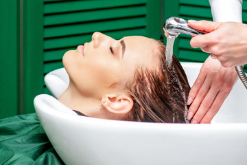 Naklejka premium Close up washing hair of woman.