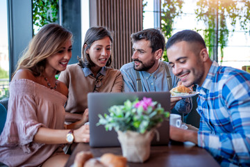 Young people browsing internet in a restaurant