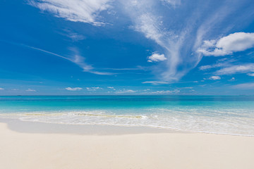 Beach nature, coastline with soft waves splashing into white sandy beach, blue sky. Tropical landscape pattern, endless blue sea, horizon. Beach and coast in a sunny day