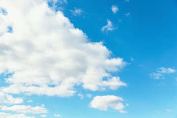 Naklejka na ściany i meble Blue sky background. Blue sky with fluffy white clouds. Copy space