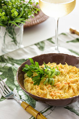 Table set for a dinner. A codfish salad with carrot, potatoes, onion and parsley is being served on a bowl, an typical portuguese dish.