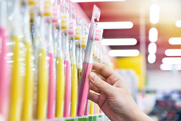 Toothbrush in package in hand in store