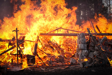 Dangerous fire. Whole house and yard on fire. A fire destroys a charred burnt house