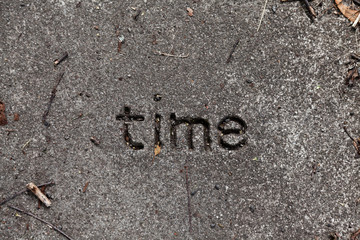 someone has carved the word time into a boulder
