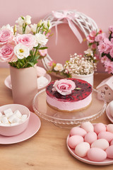 Easter table setting with cake,eggs and flowers. Happy Easter Greeting Card Template. Easter cake and colorful eggs on festive table. The concept of family celebration. Easter holiday.