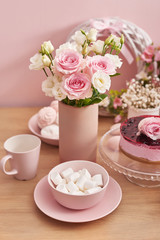 Easter table setting with cake,eggs and flowers. Happy Easter Greeting Card Template. Easter cake and colorful eggs on festive table. The concept of family celebration. Easter holiday.