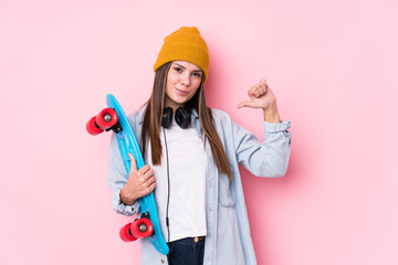 Young skater woman holding a skate feels proud and self confident, example to follow.