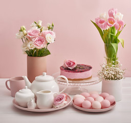 Easter table setting with cake,eggs and flowers. Happy Easter Greeting Card Template. Easter cake and colorful eggs on festive table. The concept of family celebration. Easter holiday.