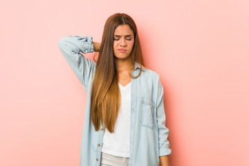Fototapeta premium Young slim woman suffering neck pain due to sedentary lifestyle.