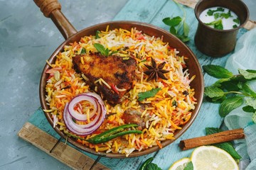 Homemade Fish Biryani served with yogurt Raita Salad, selective focus
