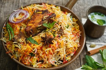 Homemade Fish Biryani served with yogurt Raita Salad, selective focus