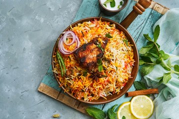 Homemade Fish Biryani served with yogurt Raita Salad, selective focus
