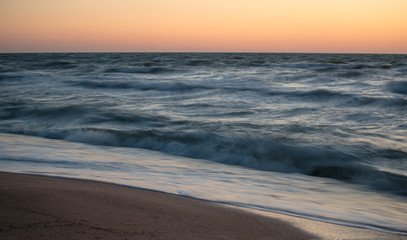 Fototapeta na wymiar Fascinating sea waves splash along the sandy beach