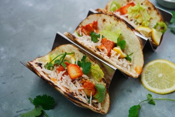 Homemade Chicken Tikka Tacos served in a metal Taco stand, selective focus