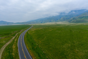 Cloudy day road to mountains