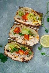 Homemade Chicken Tikka Tacos served in a metal Taco stand, selective focus