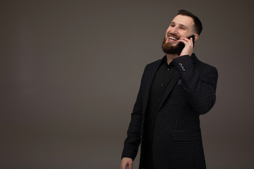 Business and phone talk concept. Man in formal suit has phone conversation. Businessman with happy...