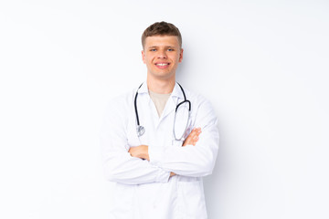 Fototapeta premium Young handsome man over isolated white background with doctor gown