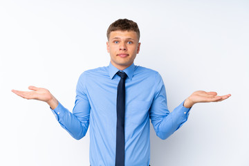 Young handsome businessman having doubts with confuse face expression