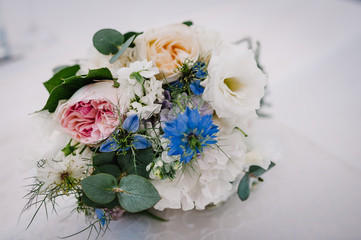 Beautiful bouquet of flowers and greenery ready for the big wedding ceremony, bridal bouquet. Decoration made of roses, peonies and decorative plants, selective focus, nobody, objects. Close up.