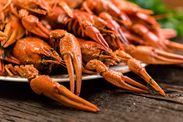 Boiled crayfish on rustic wooden background closeup