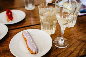 Traditional french Eclairs with original decor on a brown background table.