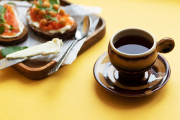 Breakfast with a cup of tea or coffee with sandwiches. Happy start to the day. Morning enjoyment, harmony and pleasure. Meal break
