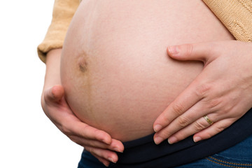 Close-up of future mom holding tummy