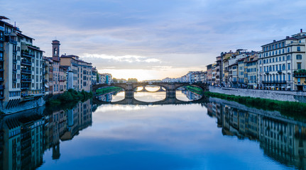 Naklejka premium Majestic view of Ponte Vecchio bridge and calm Arno river after thunderstorm in Florence Italy
