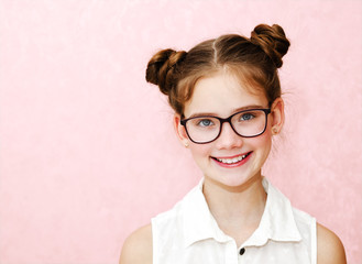 Portrait of funny smiling little girl child wearing glasses isolated - 328538366