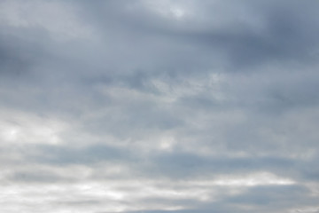 Dark gray clouds completely cover the sky in stormy weather_