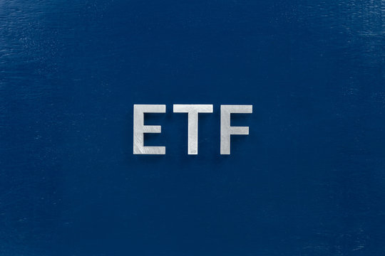 The Abbreviation Word Etf - Exchange Traded Fund - Laid With Silver Letters On Blue Color Flat Surface