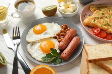 Delicious breakfast or lunch with fried eggs on wooden background, close up