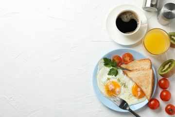 Delicious breakfast or lunch with fried eggs on white background, space for text