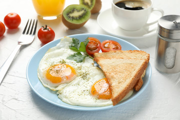 Delicious breakfast or lunch with fried eggs on white background, close up