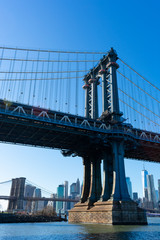 Naklejka premium The Manhattan Bridge along the East River with the Lower Manhattan Skyline in New York City