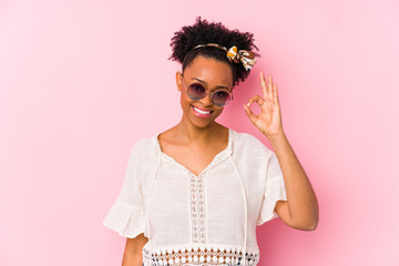 Young african american hipster woman isolated cheerful and confident showing ok gesture.