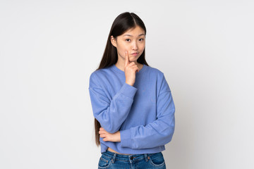 Young asian woman isolated on background and thinking