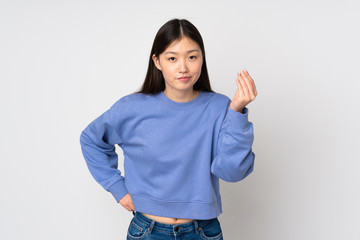 Young asian woman isolated on background making Italian gesture