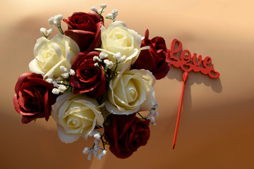 op view on a bouquet of nine red-white roses, next to the word Love.