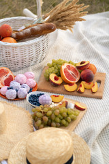 Stylish summer picnic on a white blanket.